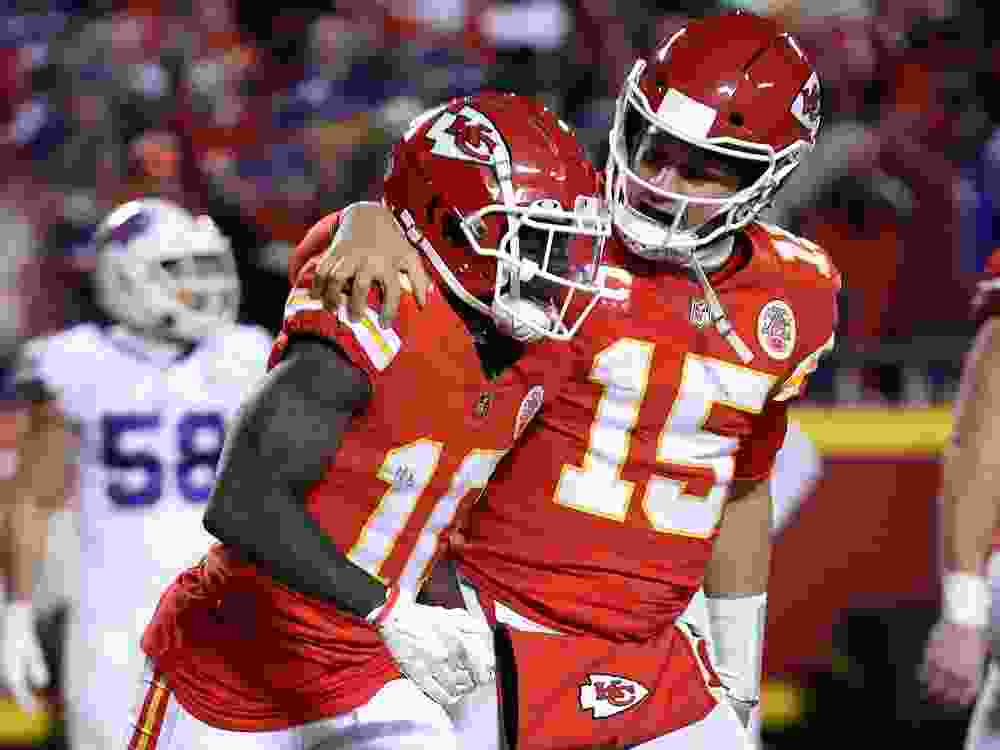 Patrick Mahomes of the Kansas City Chiefs celebrates a touchdown with Tyreek Hill during a playoff game in 2022.