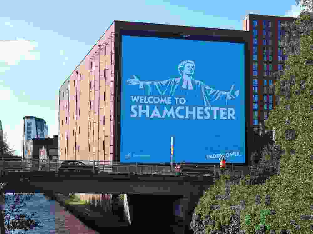 An advertisement billboard for the betting company Paddy Power, reading 'Welcome to Shamchester', is pictured in Manchester.