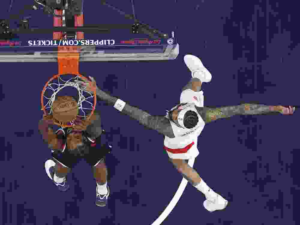 Kawhi Leonard of the Los Angeles Clippers makes a slam dunk against Brandon Ingram of the Toronto Raptors during a game last season. The pair were involved in a trade for each other this off-season.