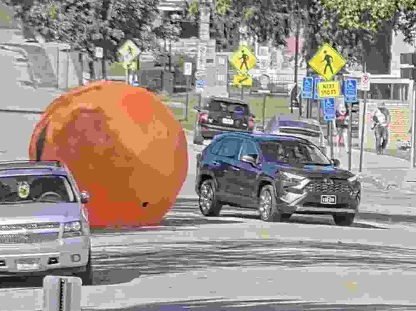 A giant inflatable pumpkin is pictured rolling down on Main St. in Dubuque, Iowa.