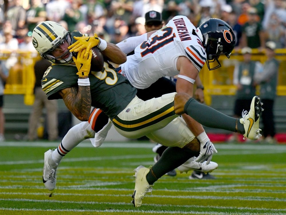 Christian Watson of the Green Bay Packers catches a touchdown pass against Dillon Thieneman of the Chicago Bears.