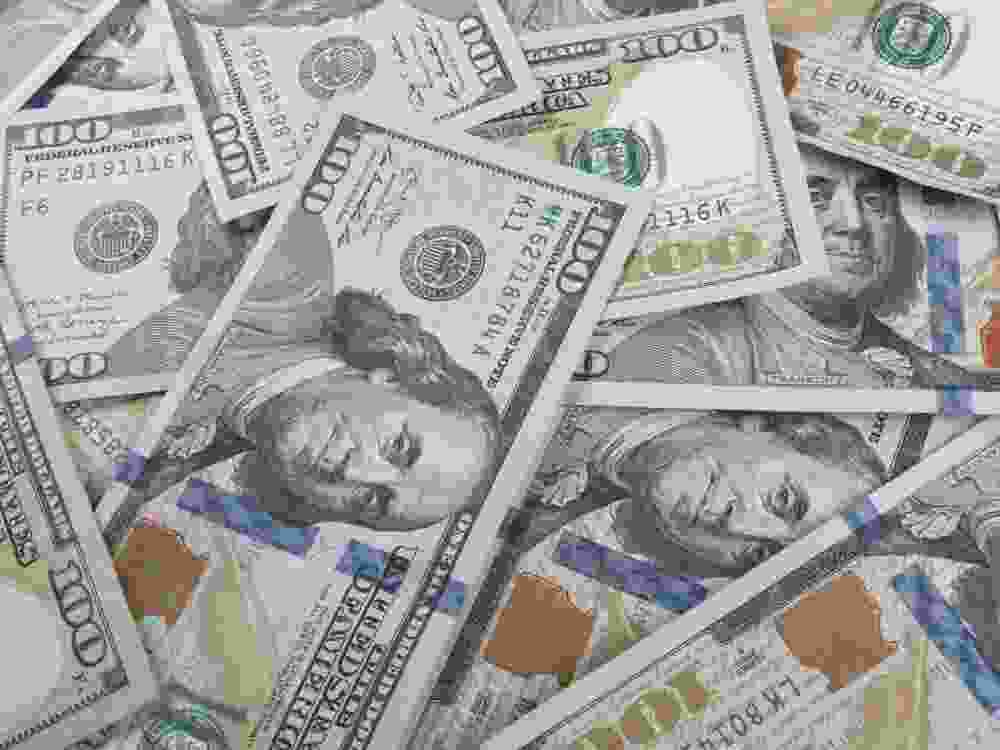 An up-close view displaying scattered U.S. currency
