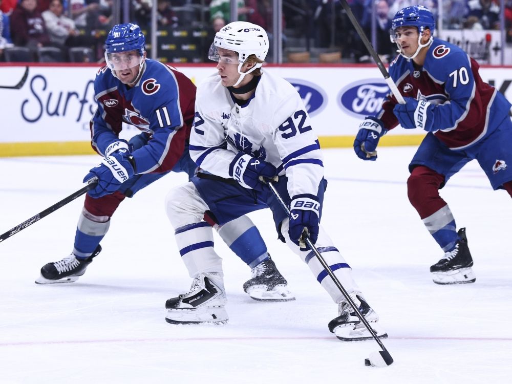 Brock Nelson of the Colorado Avalanche defends against Gavin McKenna of the Toronto Maple Leafs.