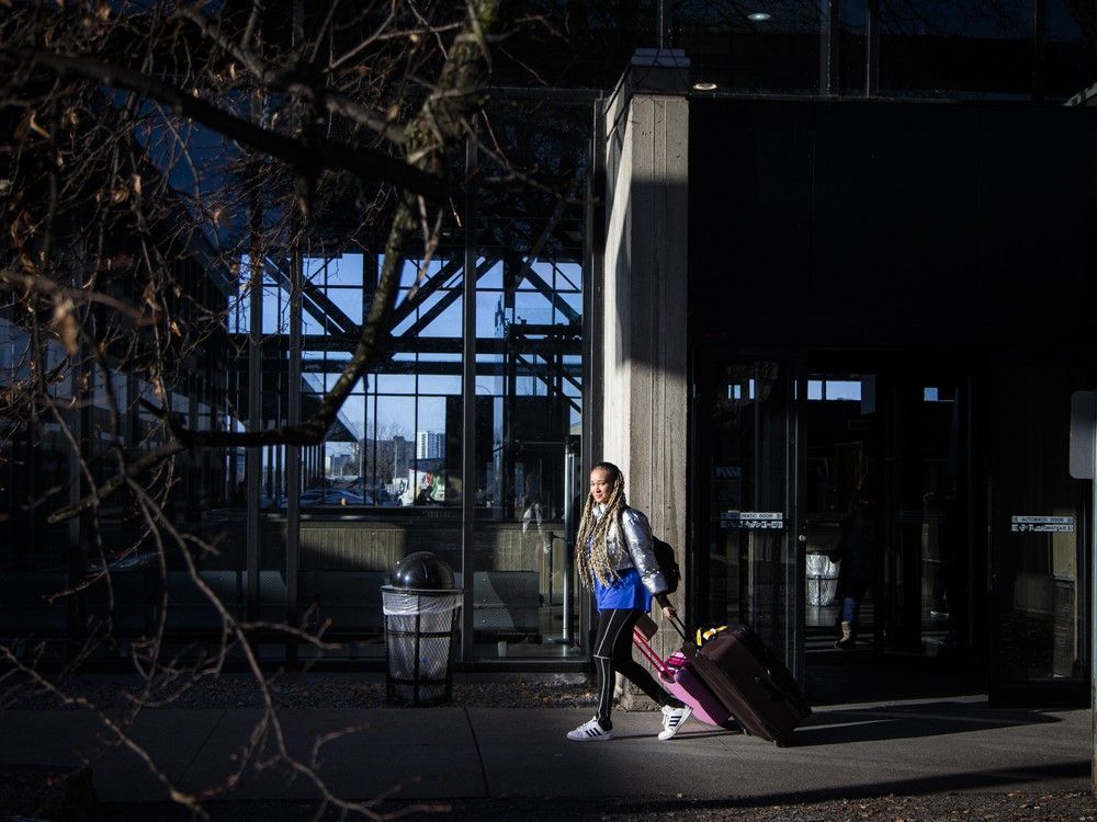 A passenger walks toward a train at the Via Rail station in Ottawa.