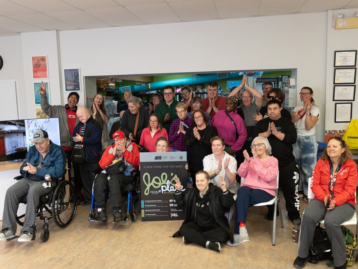 Artists and staff pose for a group photo at the National accessArts Centre in Calgary on Tuesday, Oct. 20, 2026, following an announcement of a new space in Toronto.