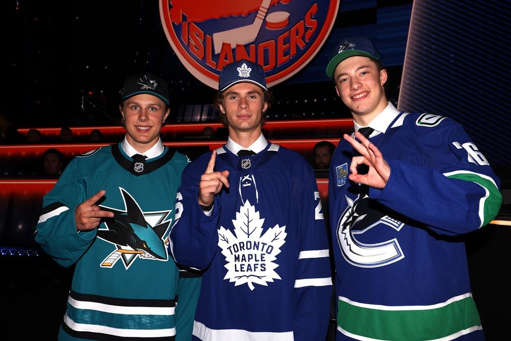 From left: Ivar Stenberg of the San Jose Sharks, Gavin McKenna of the Toronto Maple Leafs, and Caleb Malhotra of the Vancouver Canucks pose for a picture during day one of the 2026 NHL Draft on June 26, 2026 in Buffalo.