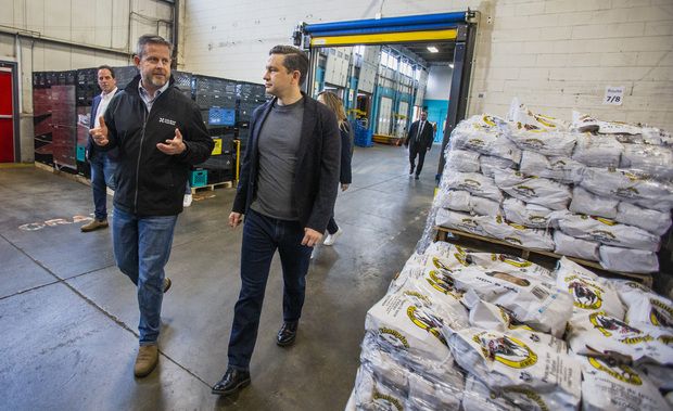 Daily Bread Food Bank CEO Neil Hetherington (left) shows Conservative Party Leader Pierre Poilievre around the facility during a visit to the Daily Bread Food Bank in the Etobicoke area of Toronto on Friday April 19, 2024.