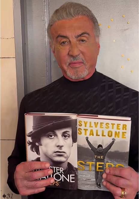 Sylvester Stallone poses with a copy of his memoir ‘The Steps.’