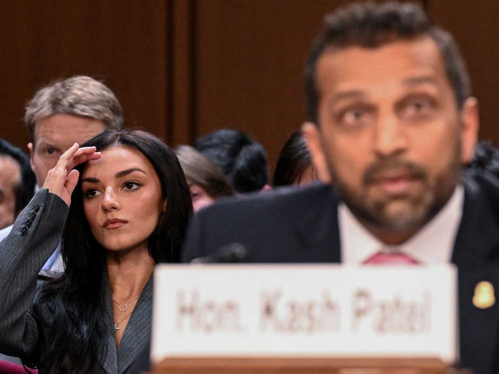 Singer Alexis Wilkins, left, girlfriend of FBI Director Kash Patel, looks on as Patel testifies during a Senate Judiciary Committee hearing on FBI oversight, on Capitol Hill in Washington, D.C., on Sept. 15, 2026.